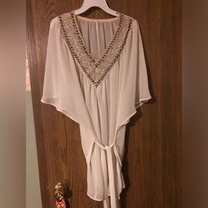 Cream, sheer, jeweled collar blouse.